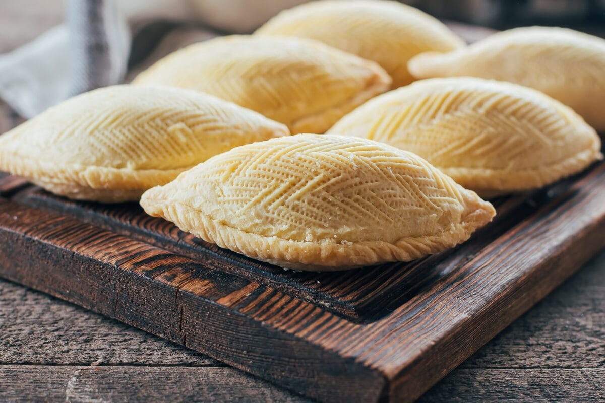 Azerbaijan national dessert. Oriental Sweet Pastry Dessert - Shekerbura on wooden board on table
