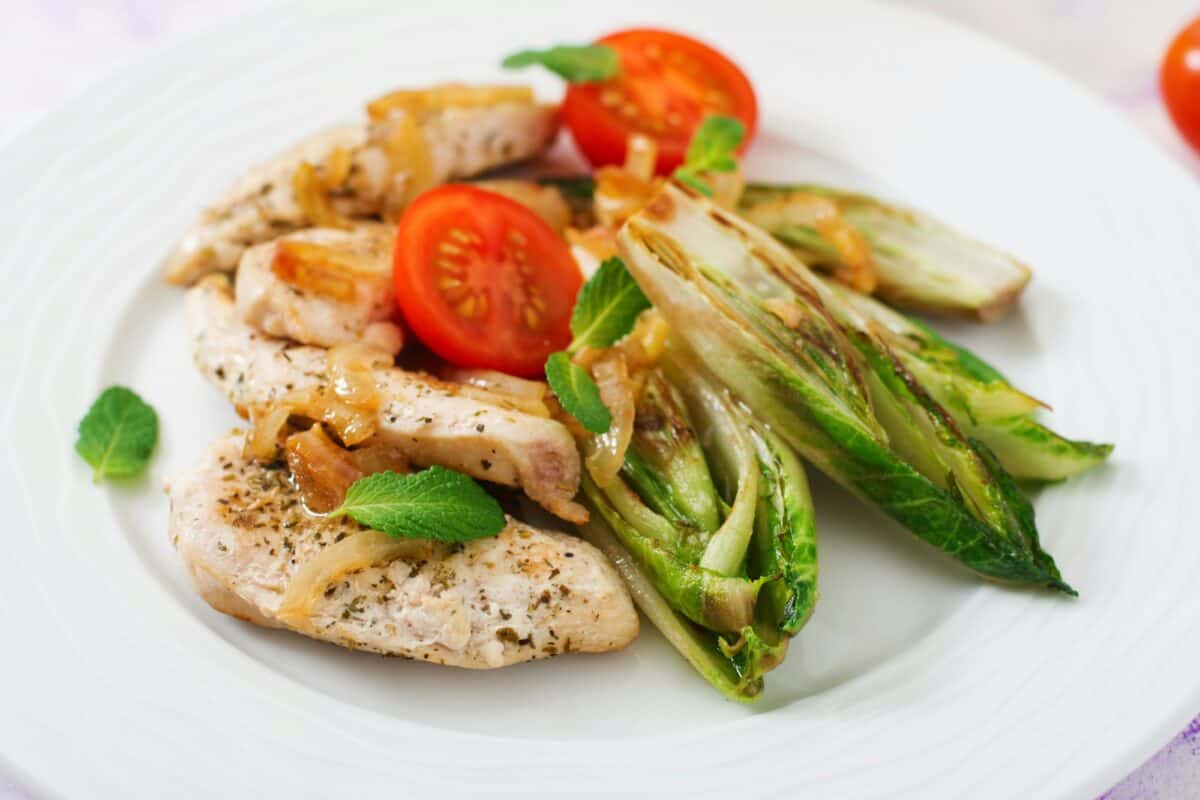 Baked chicory with chicken, onions and herbs.