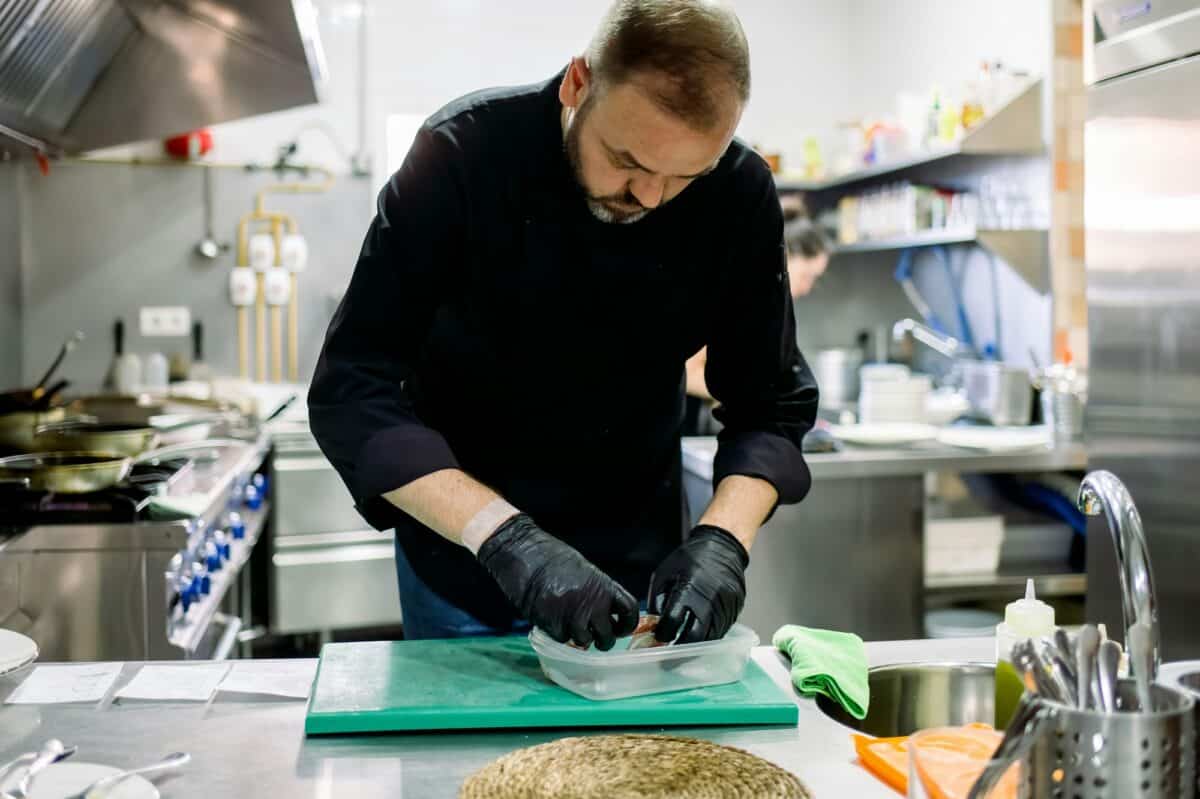 Bearded male professional chef working in professional kitchen