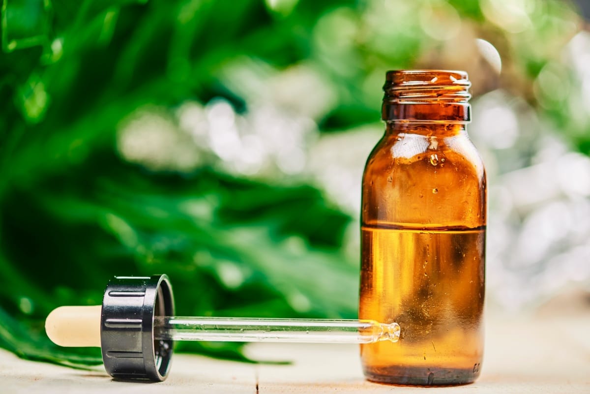 compte-gouttes et bouteille d'huile de cbd sur un PETS Alternative Therapy