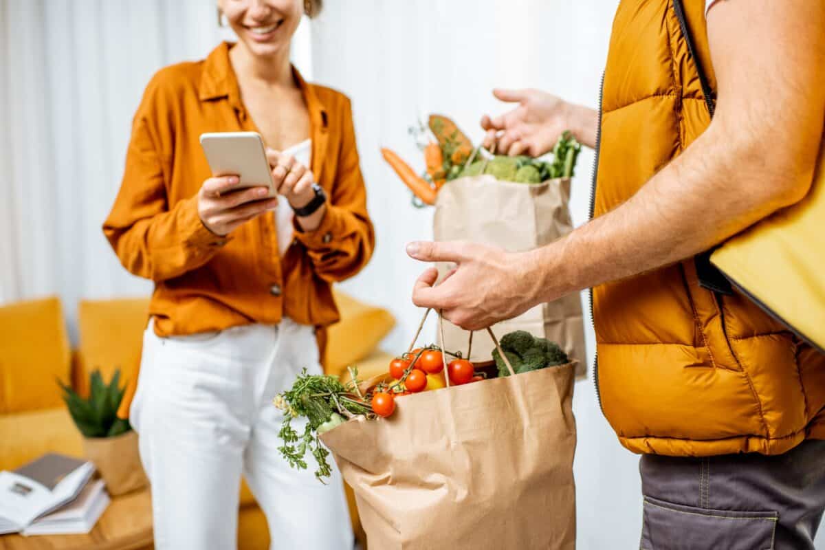 Courier delivering groceries home