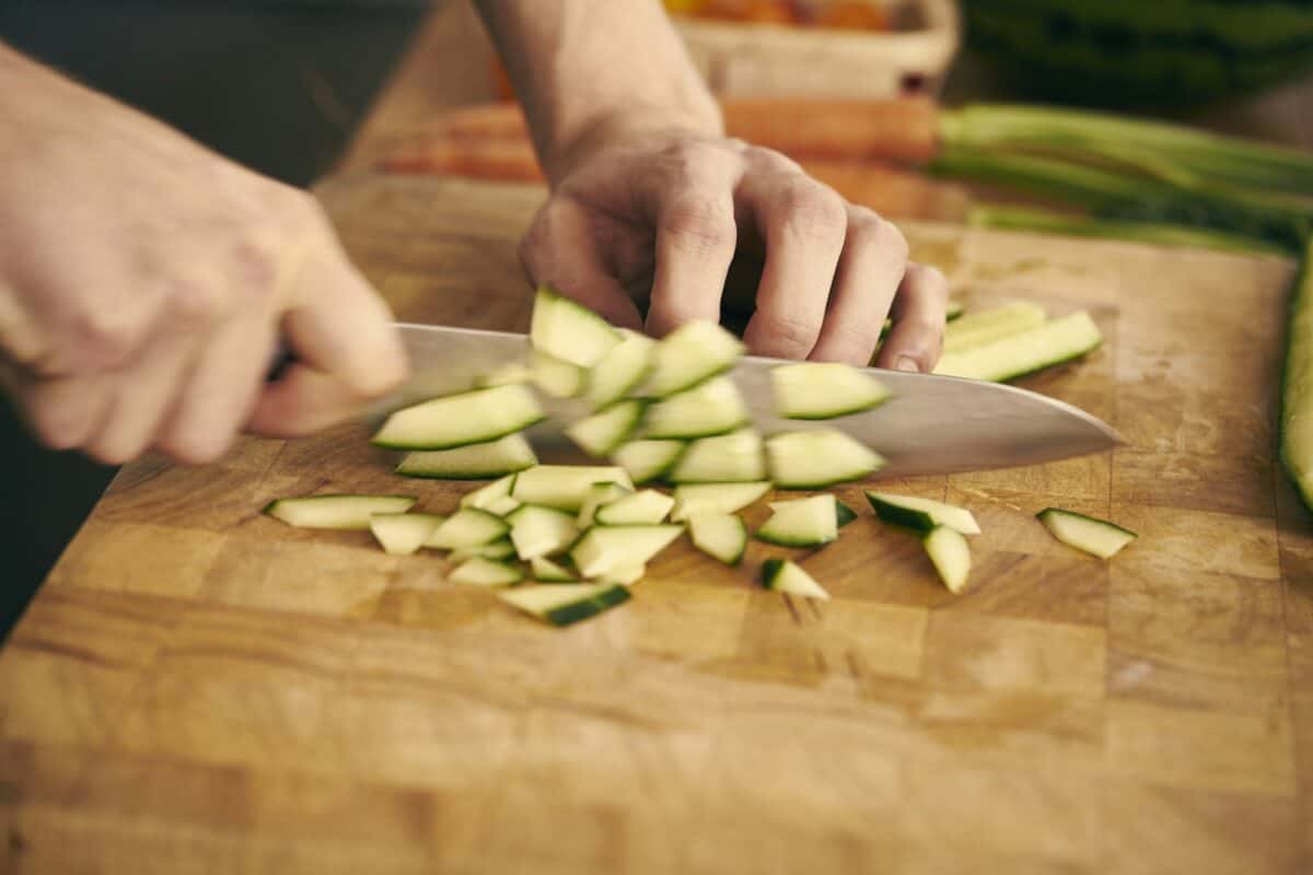 Cropped view of chef chopping vegetables