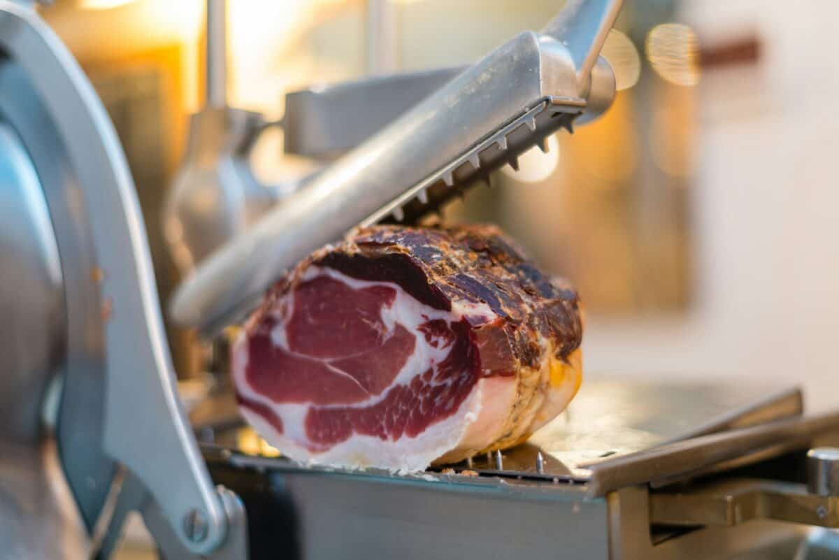 Cutting machine for slicing traditional Italian "coppa piacentina"