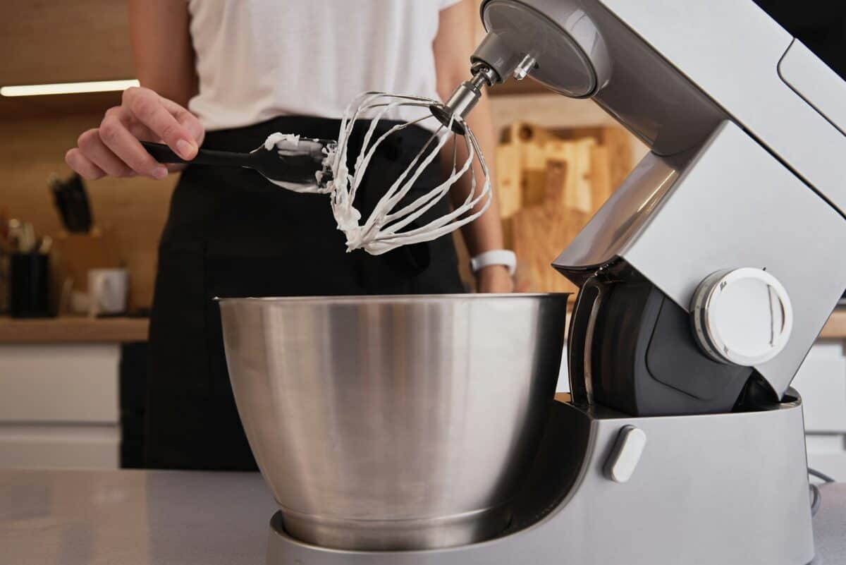 Femme utilisant un robot pour cuisiner dans une cuisine