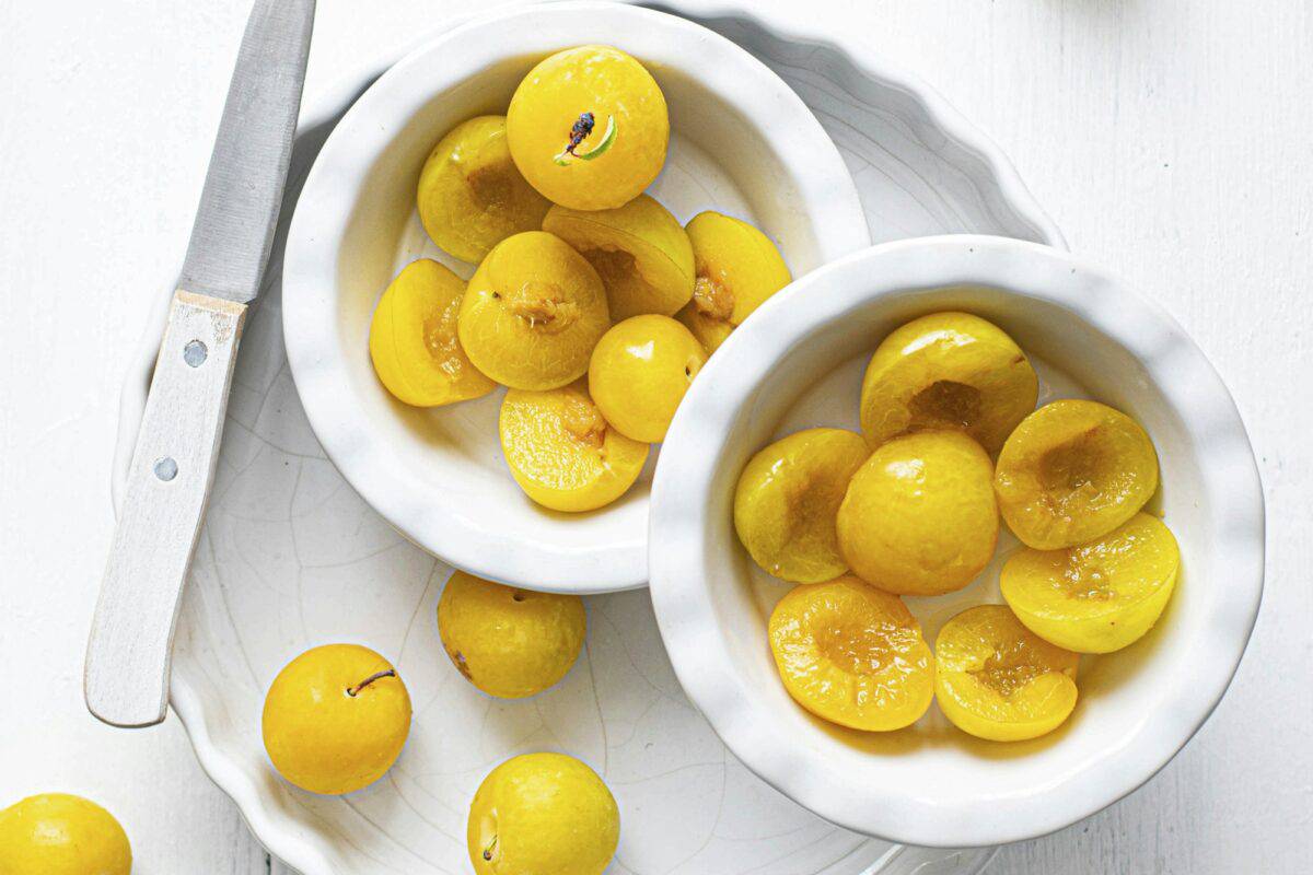 Fresh sliced mirabelle plums in a bowl