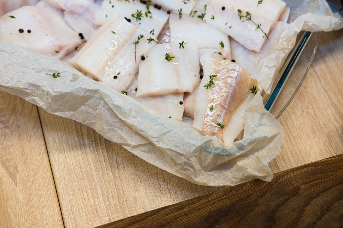 Fresh white fish fillet on cooking paper