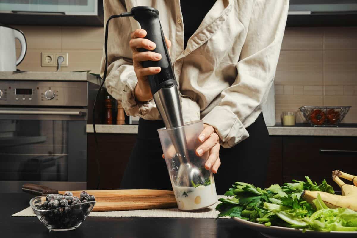 Hands of unrecognizable woman using blender