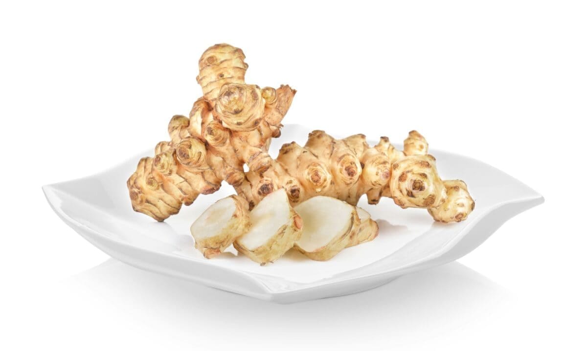 Jerusalem artichoke in plate (beautiful shape) on white backgrou