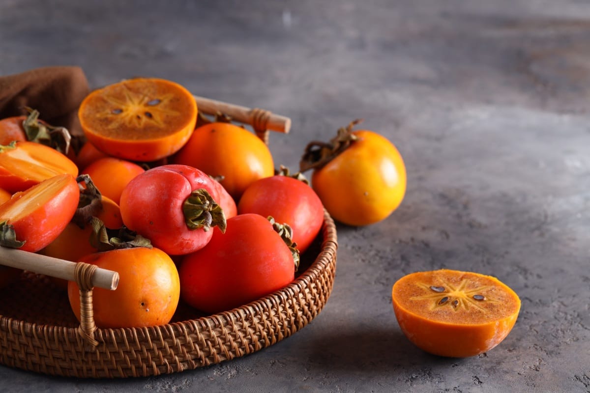 ripe persimmon orange fruit in a basket