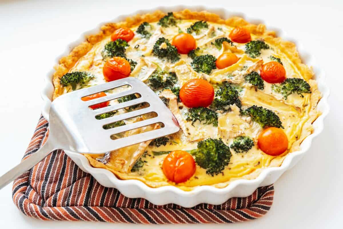 Open pie with vegetables and cheese in baking dish