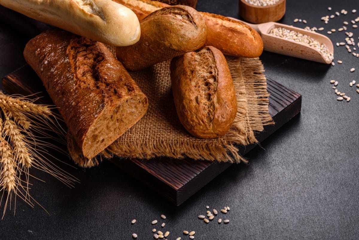 Fresh Bread on black background, top view, copy space