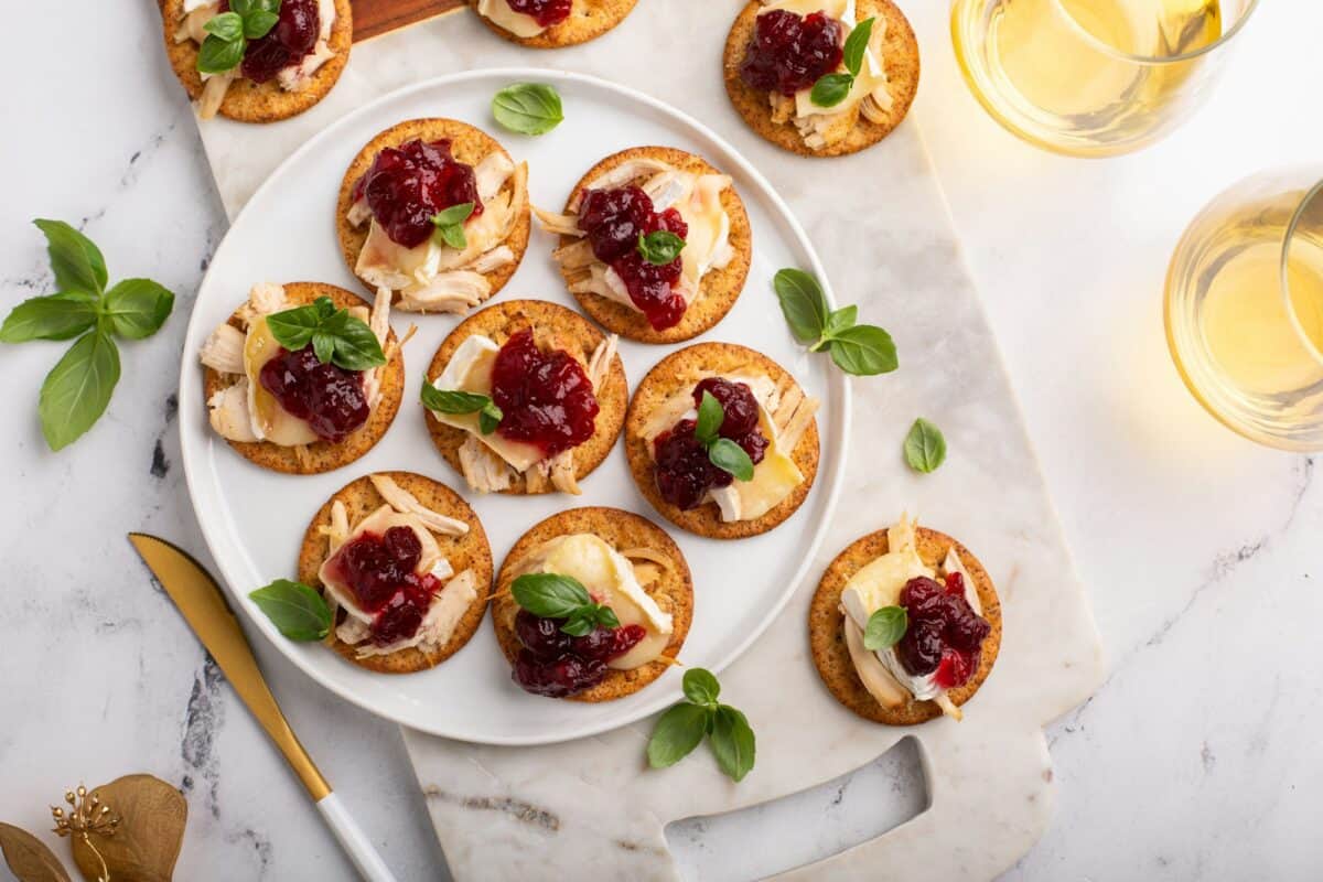 Party appetizers with turkey, brie and cranberry sauce