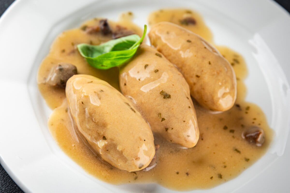 quenelles pork mushroom sauce canned food jar put food on a plate eating cooking appetizer meal food