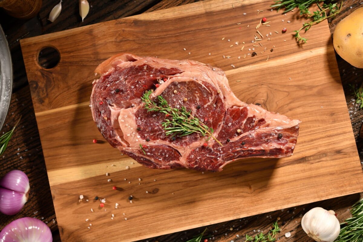 Raw seasoned rib eye steak