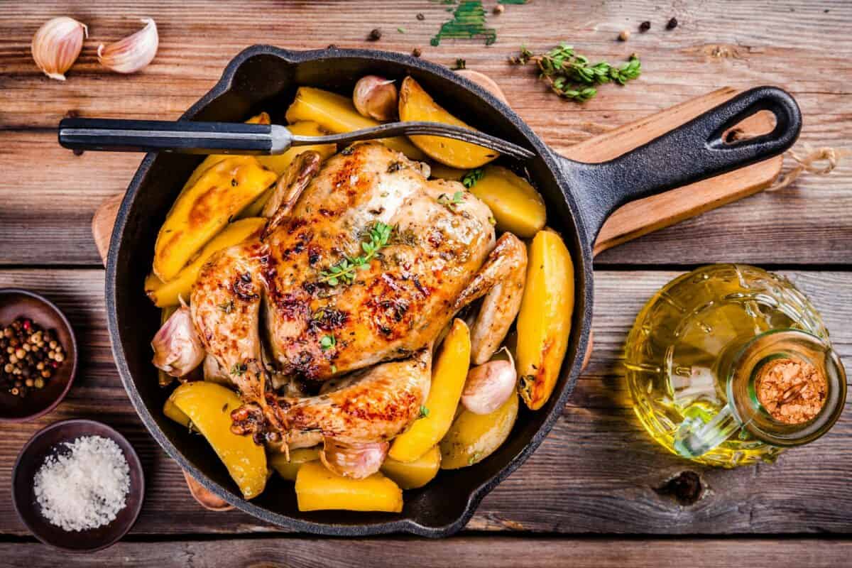 Roasted whole chicken with potatoes and thyme