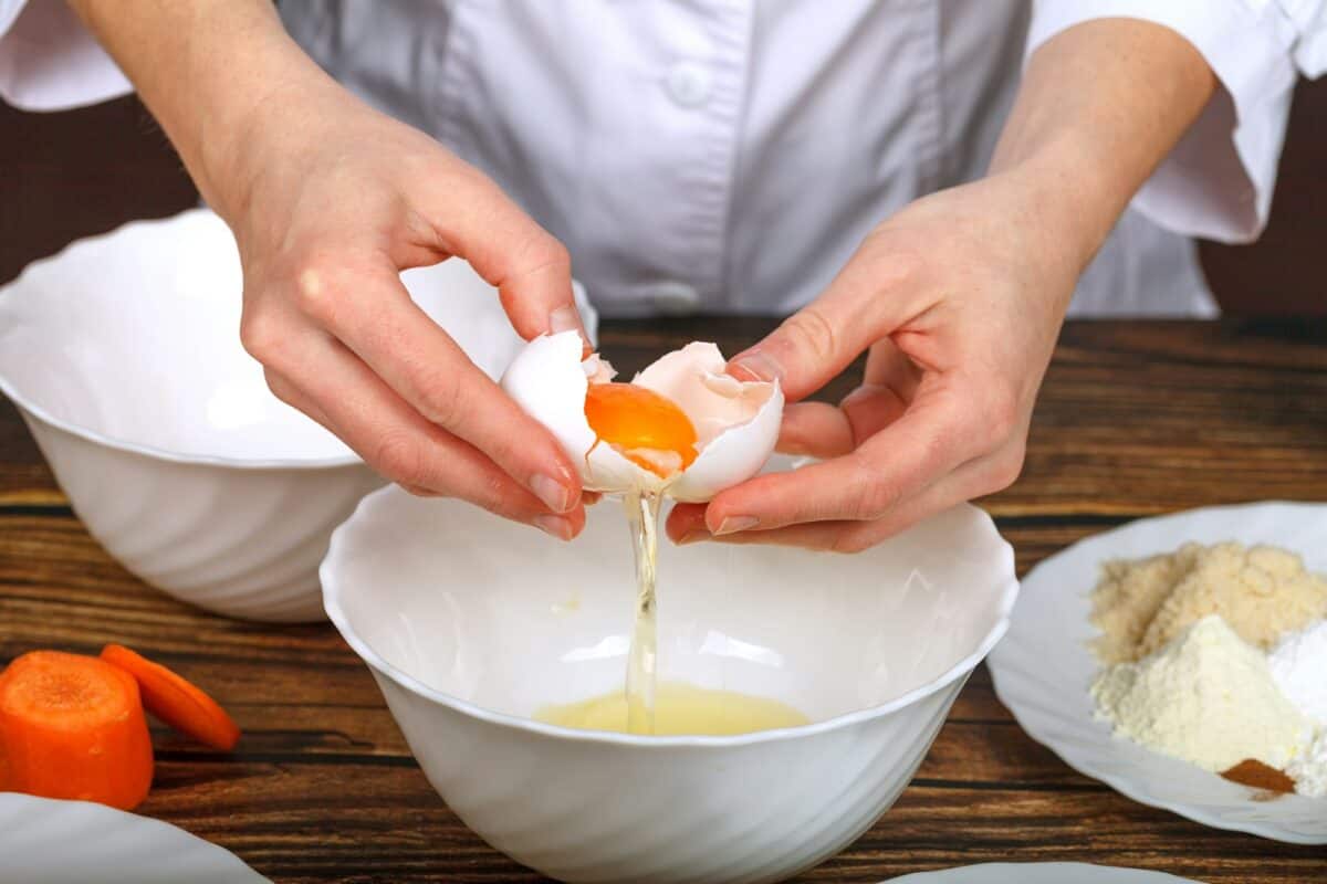Separating the yolks from the whites in raw eggs for making a cake.