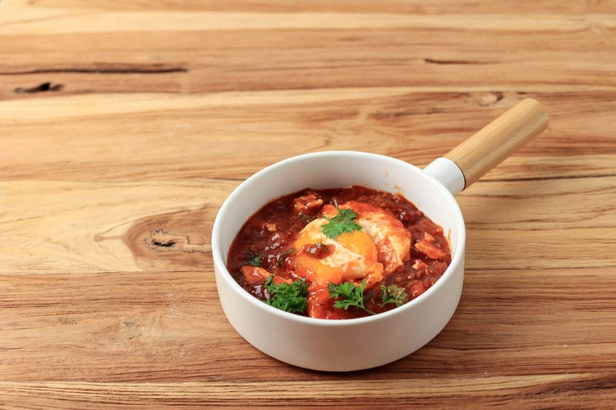 Shakshouka, Eggs Poached in Tomato Sauce, Olive Oil, Peppers, Onion, and Garlic.