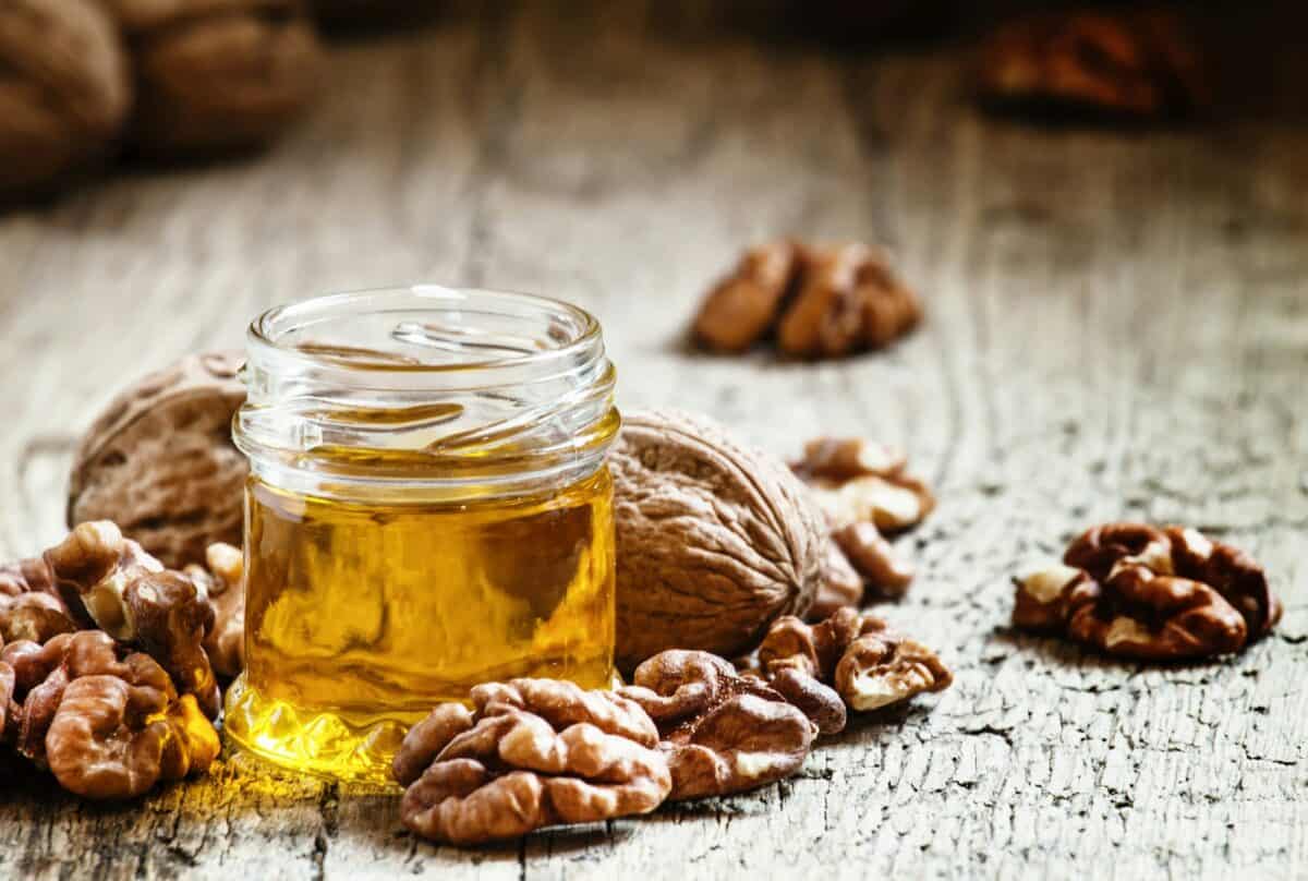 Walnut oil in a small jar and kernels