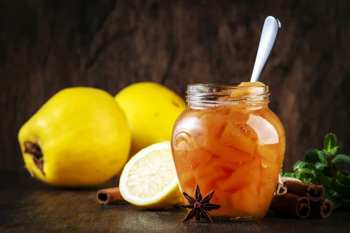 Winter Quince jam or confiture in glass jar with cinnamon and anise