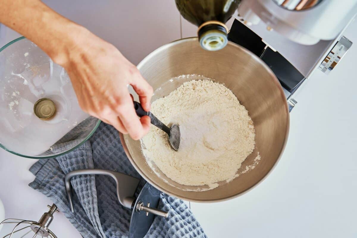 Woman cooking at kitchen and using kitchen machine