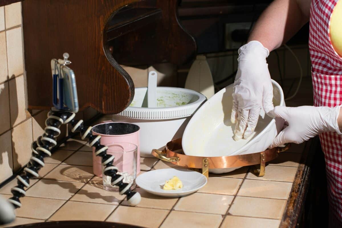 woman cooking spinach muffin step by step, mixing ingredients with mixer, recording video on mobile