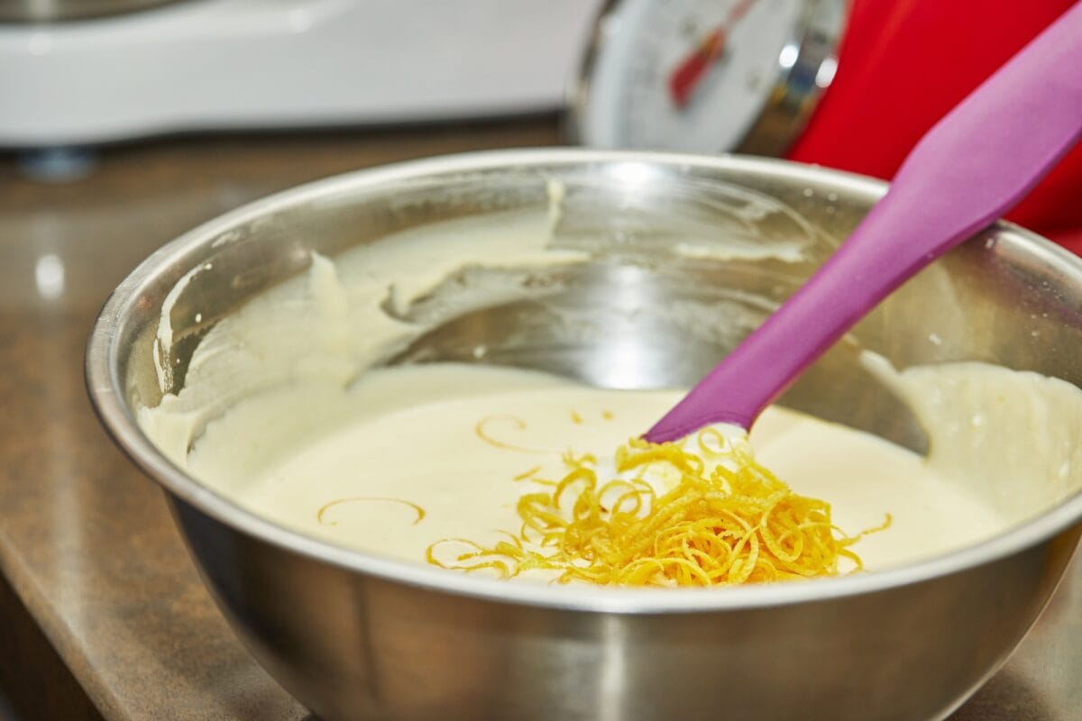 Woman stirring dough with spatula to make cheese pie with zest, step by step